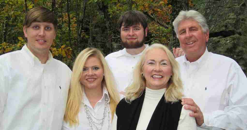 The Hooks family, owners and directors of Riverview, outdoors among autumn trees