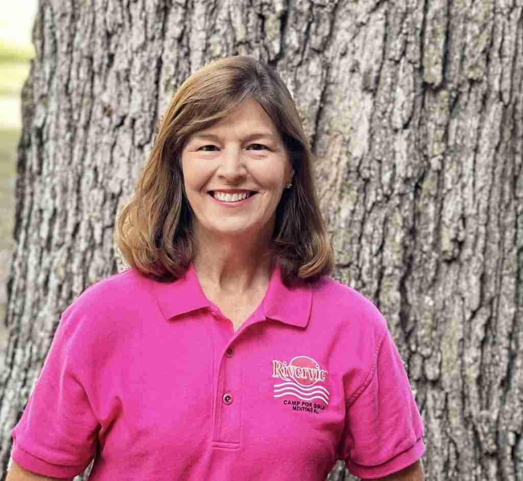 Donna Bares, Assistant Director, smiling in a pink Riverview shirt