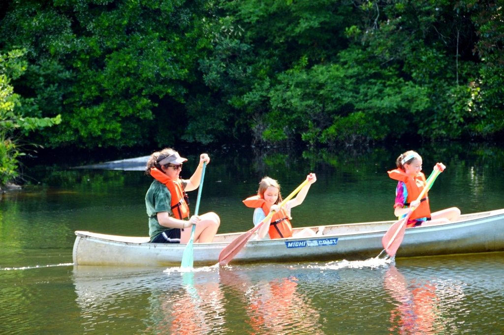 Campers paddling a canoe at Riverview