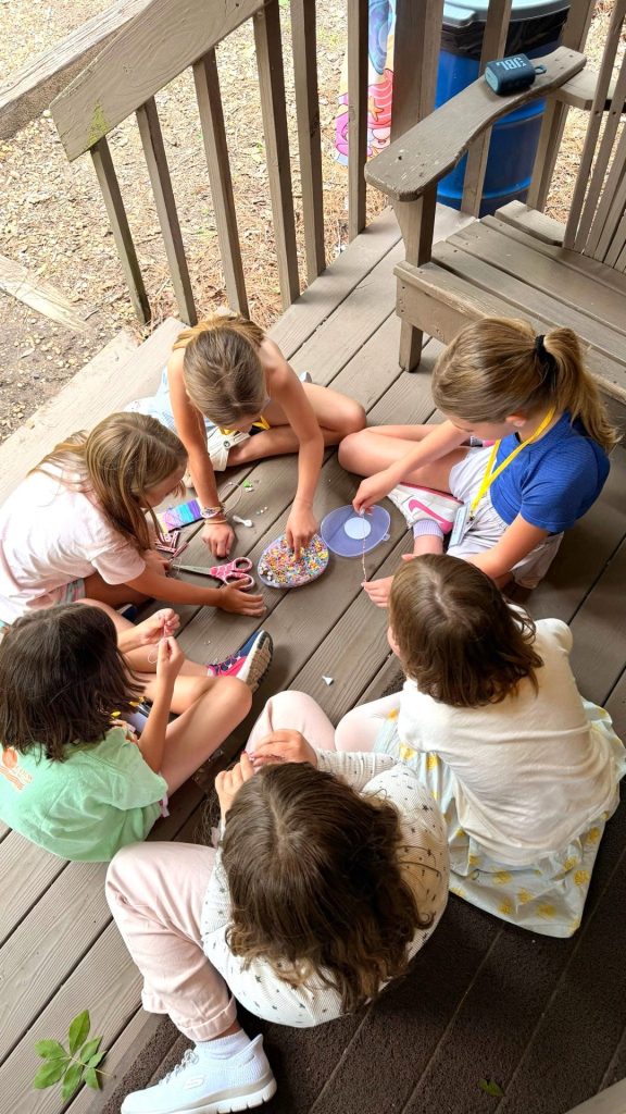 Campers relaxing together on a cabin porch