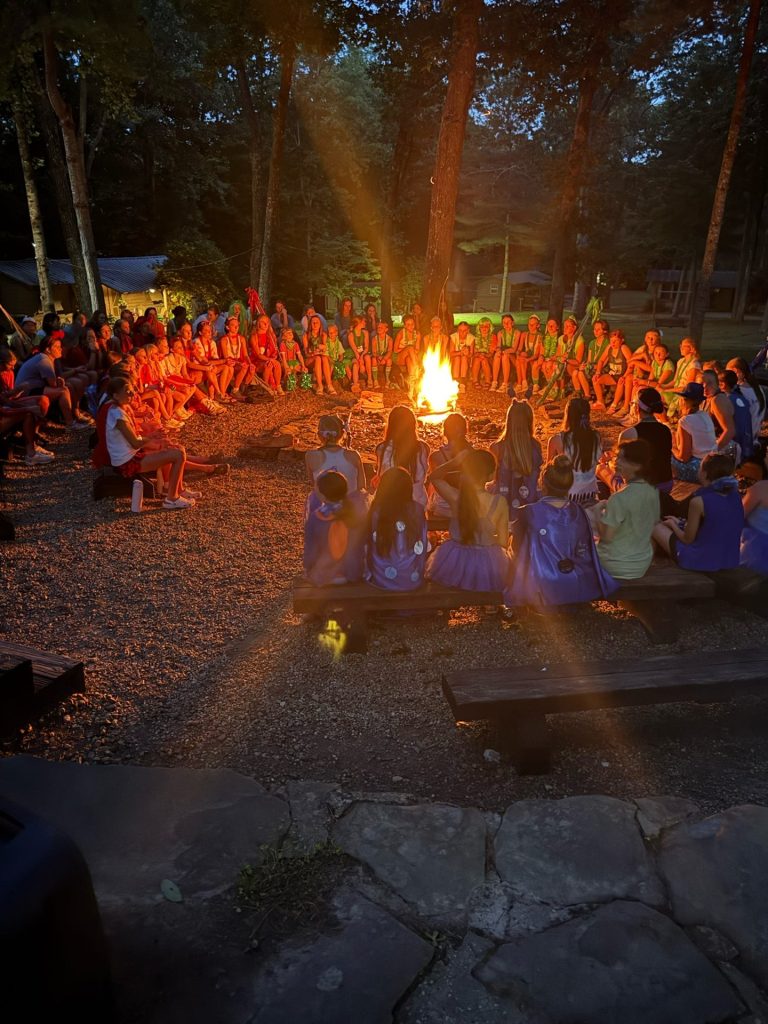 Campers gathered around the evening campfire
