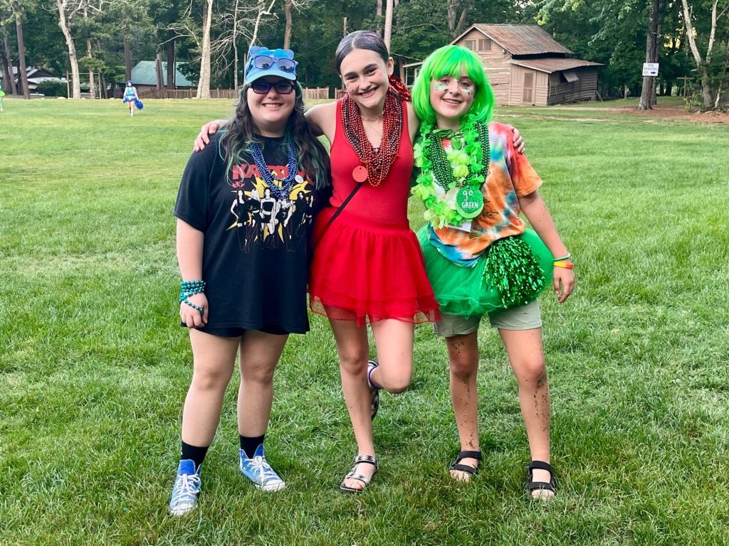 Three cabin mates dressed up for a camp theme night